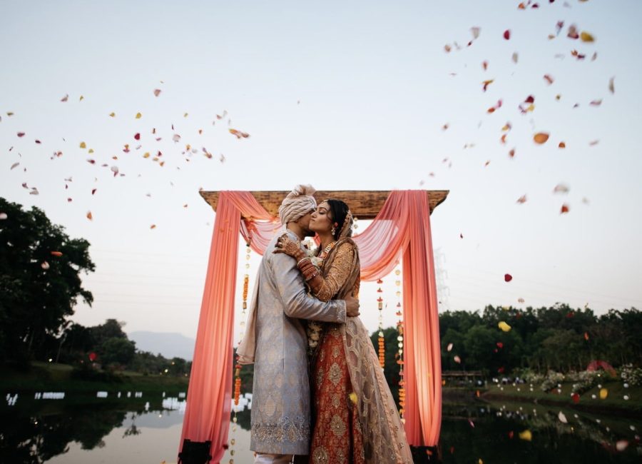 Couple exchanging vows under a decorated mandap